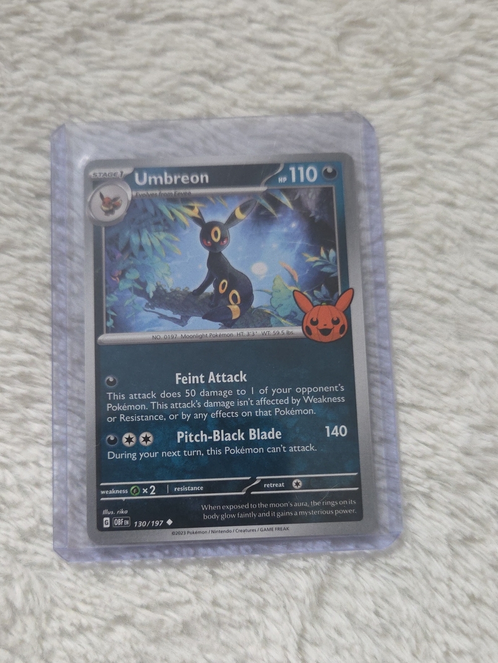 Umbreon (130/197) uncommon card featuring the special Pikachu pumpkin stamp